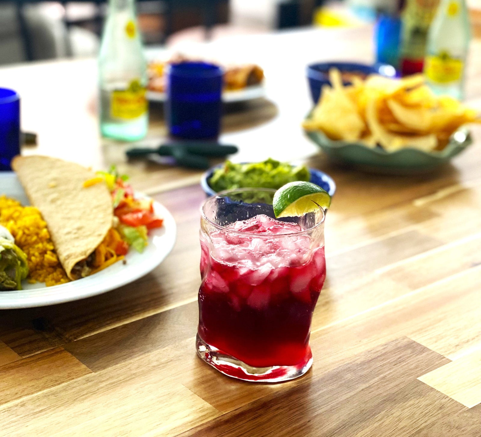 Iced glass of Ranch water with lime on rim and a plate of Tex-Mex